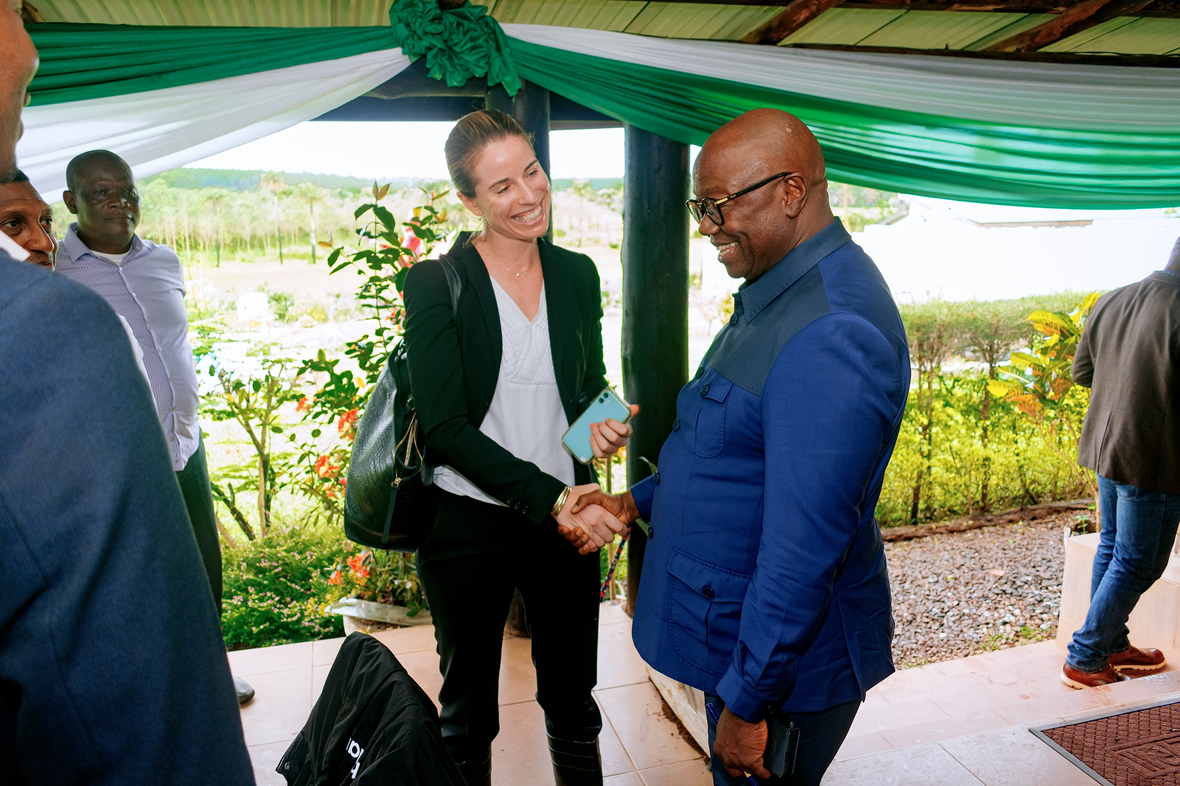 Tessa Lee, Chief Regulatory Officer at CrossBoundary Energy, shakes the hand of Sierra Leone's Minister of Energy, Alhaji Kanja Sesay